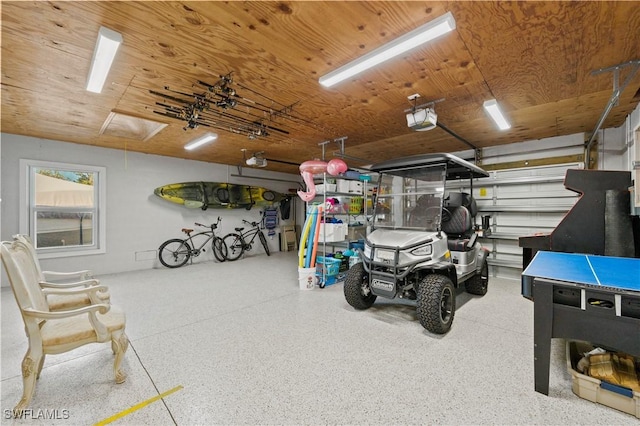 garage featuring wooden ceiling and a garage door opener