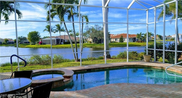 view of pool with a lanai, a water view, and an in ground hot tub