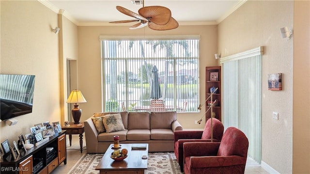 tiled living room featuring ceiling fan and ornamental molding