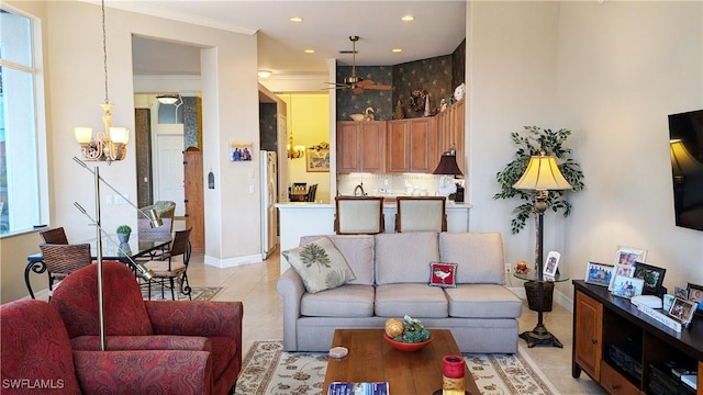 tiled living room with ceiling fan and ornamental molding