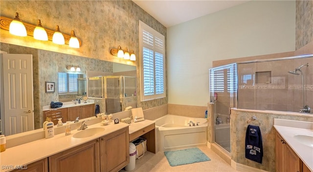 bathroom with shower with separate bathtub, vanity, and a wealth of natural light