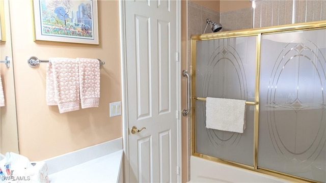 bathroom featuring bath / shower combo with glass door