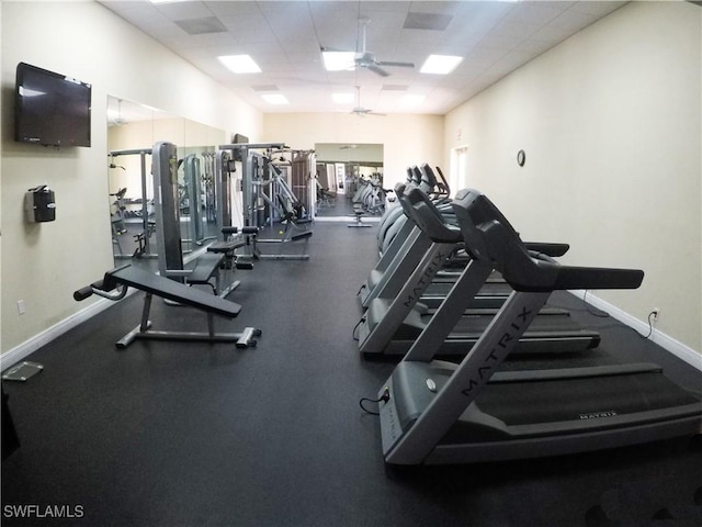 exercise room featuring a paneled ceiling and ceiling fan