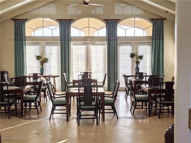 dining room with a high ceiling and ceiling fan