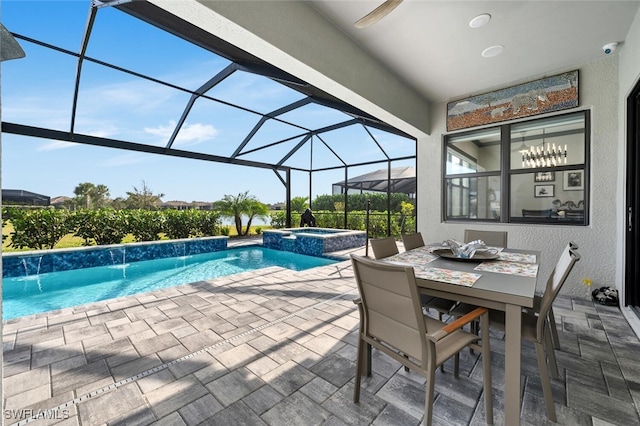 view of pool with a lanai, pool water feature, an in ground hot tub, and a patio area