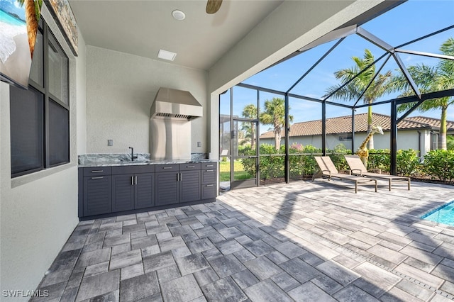 view of patio / terrace featuring sink and glass enclosure