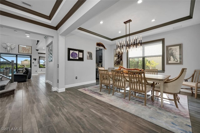 dining area with dark wood-type flooring, a chandelier, and a healthy amount of sunlight