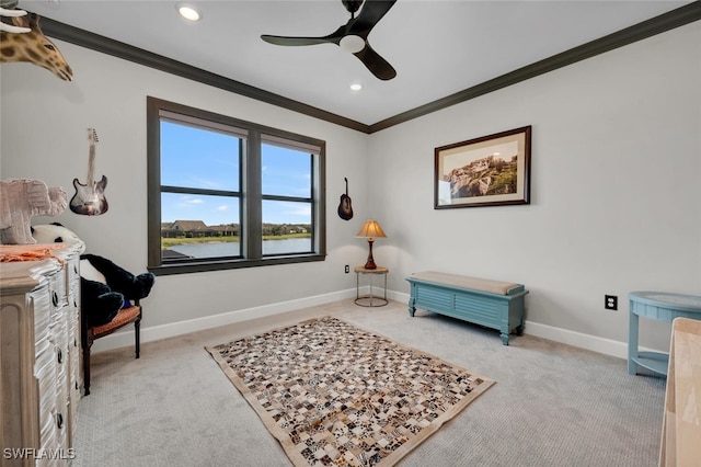 living area with ceiling fan, crown molding, light carpet, and a water view