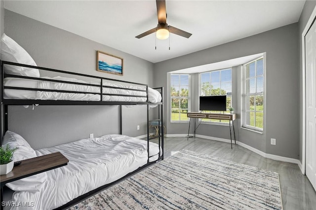 bedroom with ceiling fan and light hardwood / wood-style floors