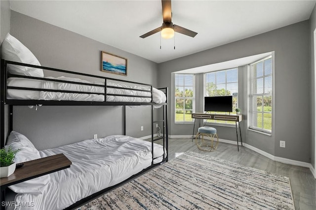 bedroom with light hardwood / wood-style flooring and ceiling fan