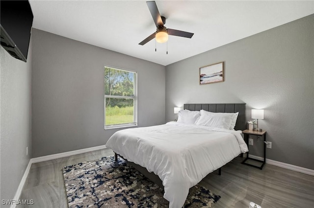 bedroom with wood-type flooring and ceiling fan