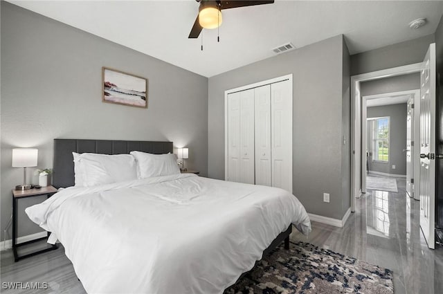 bedroom featuring ceiling fan, wood-type flooring, and a closet