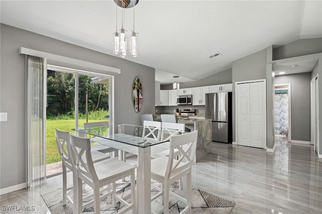 dining area featuring lofted ceiling