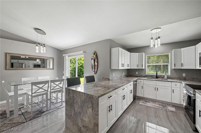 kitchen with sink, hanging light fixtures, white cabinetry, kitchen peninsula, and stainless steel appliances