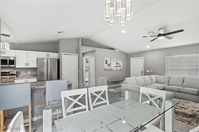 dining area with ceiling fan and vaulted ceiling