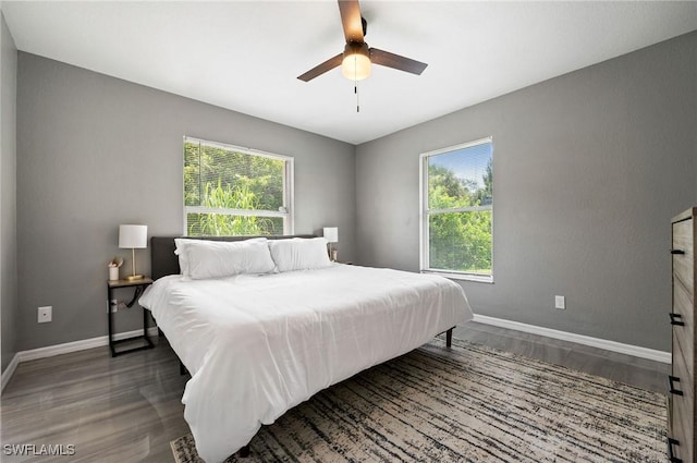 bedroom featuring ceiling fan and dark wood-type flooring