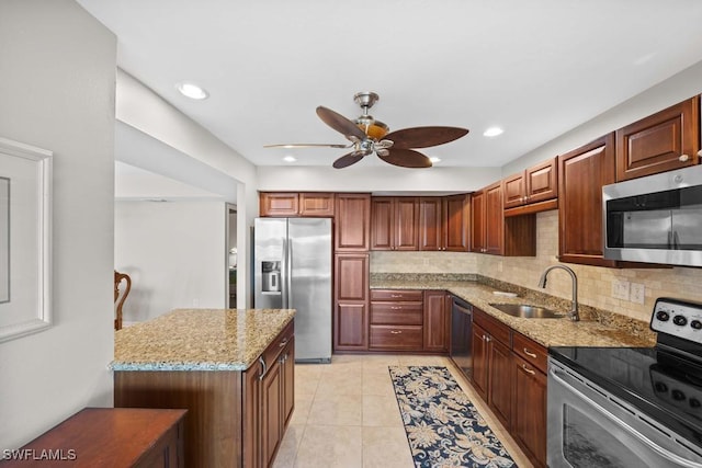 kitchen with light tile patterned flooring, light stone countertops, sink, and appliances with stainless steel finishes