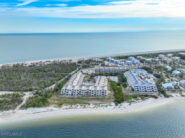 drone / aerial view with a beach view and a water view