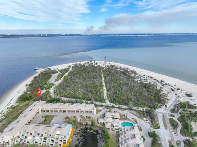 birds eye view of property featuring a water view and a beach view