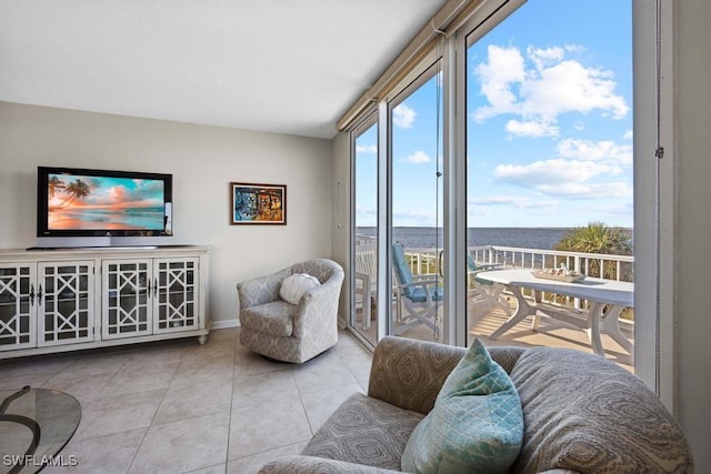 tiled living room with a water view