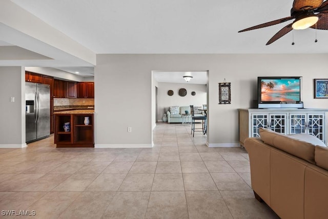 tiled living room featuring ceiling fan