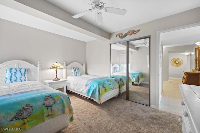 bedroom featuring ceiling fan, a closet, and light colored carpet