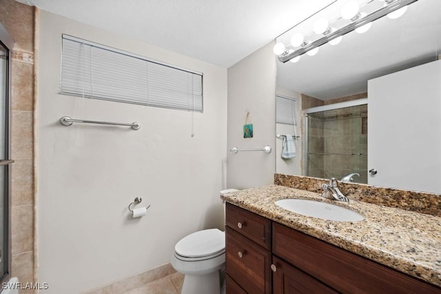 bathroom with tile patterned floors, vanity, toilet, and a shower with shower door