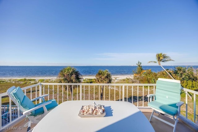 balcony featuring a water view and a view of the beach