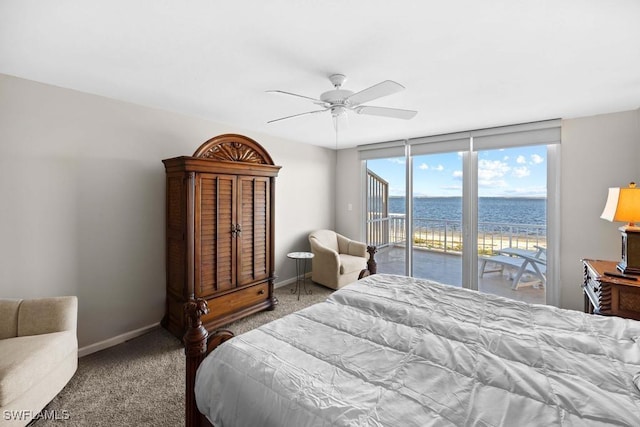 bedroom with carpet, ceiling fan, a water view, and access to outside