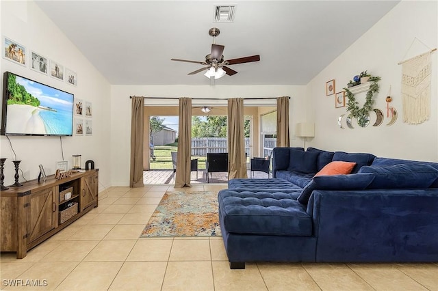 tiled living room with lofted ceiling and ceiling fan