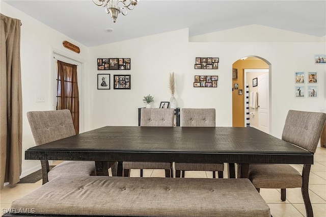 dining space with vaulted ceiling and light tile patterned floors