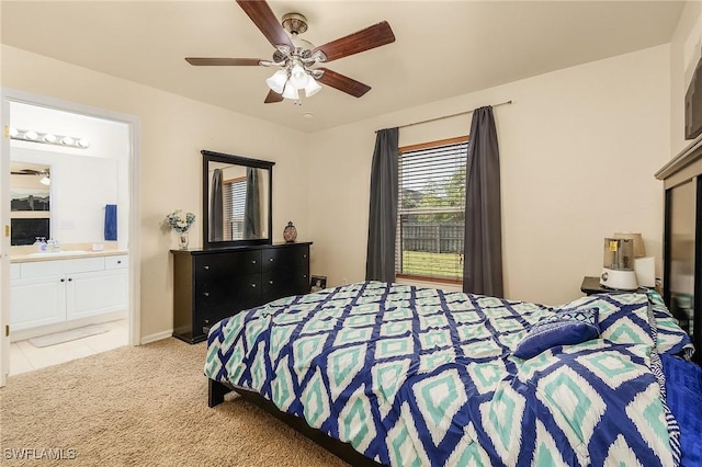 carpeted bedroom with ceiling fan and connected bathroom