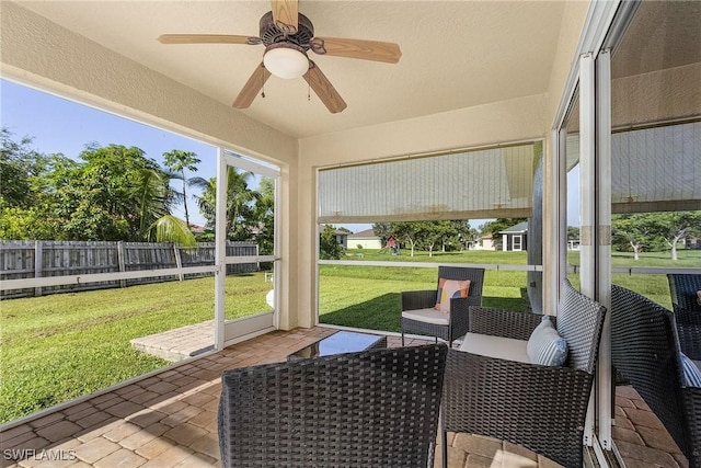 sunroom featuring ceiling fan