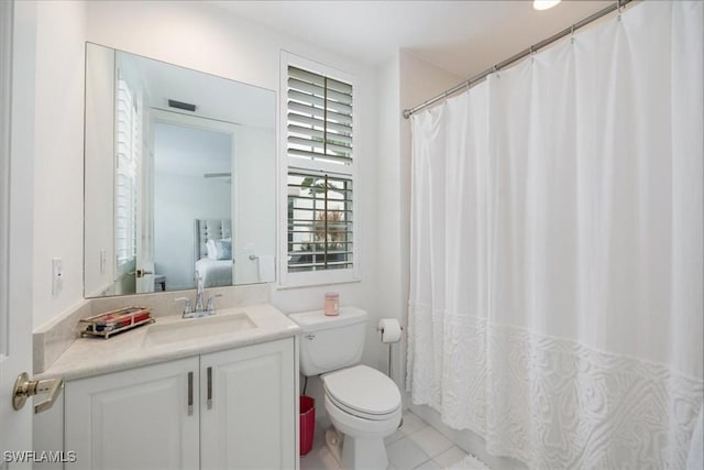 bathroom with vanity, tile patterned floors, and toilet