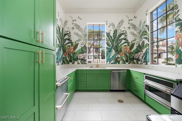 kitchen with ornamental molding, appliances with stainless steel finishes, sink, and green cabinets