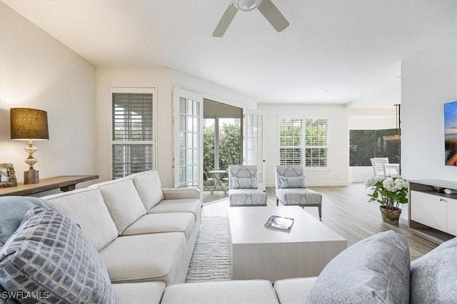 living room featuring ceiling fan and light wood-type flooring