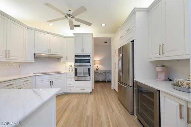 kitchen with wine cooler, white cabinetry, appliances with stainless steel finishes, ceiling fan, and light hardwood / wood-style floors