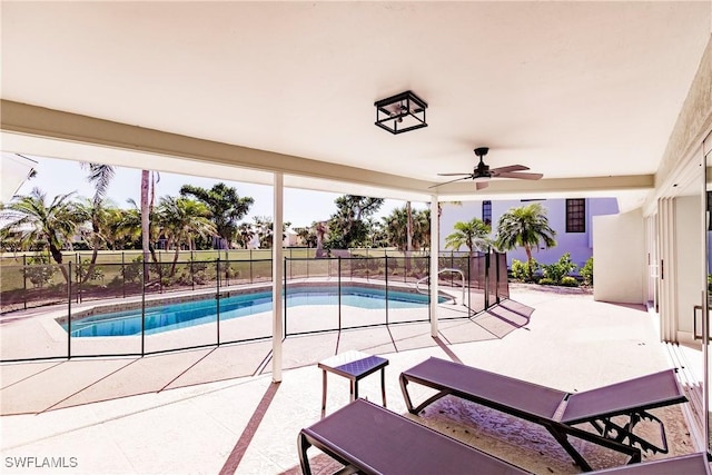 view of swimming pool featuring ceiling fan and a patio area