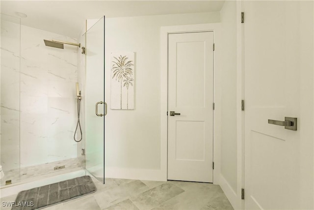 bathroom with a shower with door