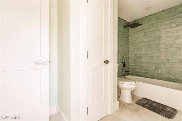 bathroom featuring tile patterned floors, toilet, and tiled shower / bath