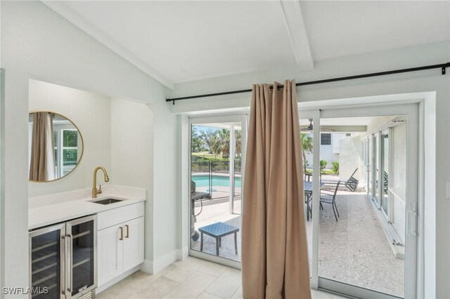 1298 Par View Dr, Sanibel, FL 33957 - indoor wet bar with beverage cooler, baseboards, and light tile patterned floors
