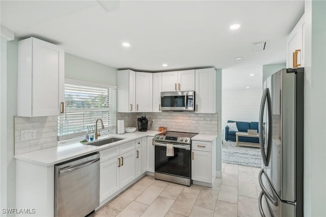 1298 Par View Dr, Sanibel, FL 33957 - kitchen featuring appliances with stainless steel finishes, a sink, white cabinets, light countertops, and recessed lighting