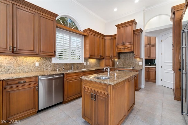 kitchen featuring sink, light stone counters, stainless steel dishwasher, a kitchen island with sink, and ornamental molding