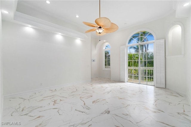 empty room featuring ceiling fan and ornamental molding