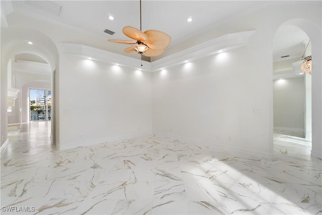 unfurnished room featuring ceiling fan and ornamental molding