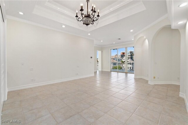 unfurnished room featuring an inviting chandelier, ornamental molding, light tile patterned floors, and a tray ceiling