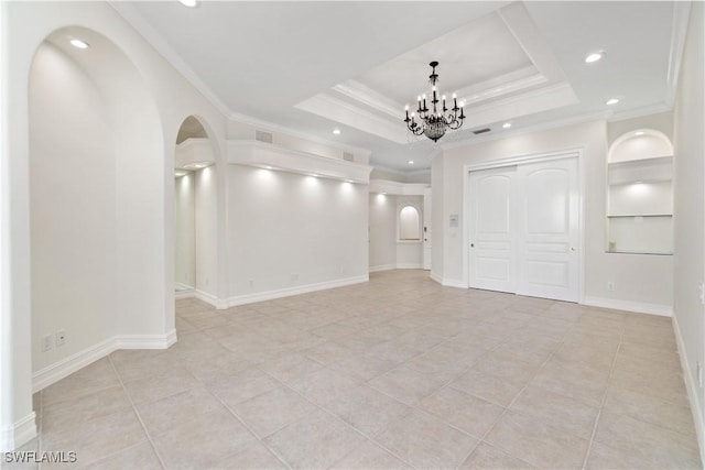 interior space with a chandelier, crown molding, and a tray ceiling