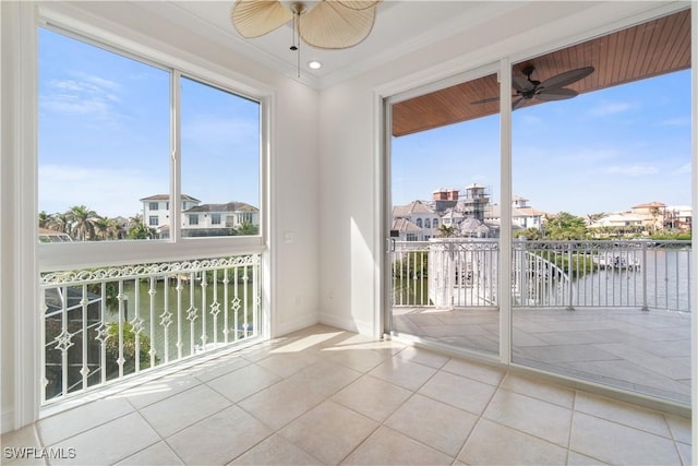 unfurnished sunroom featuring a water view