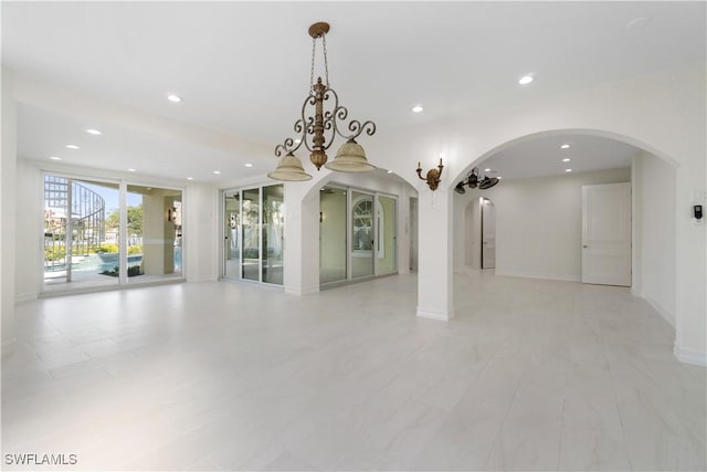 interior space featuring floor to ceiling windows and an inviting chandelier