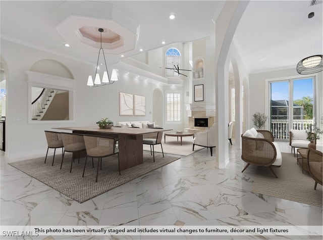 dining room featuring an inviting chandelier, crown molding, and a healthy amount of sunlight